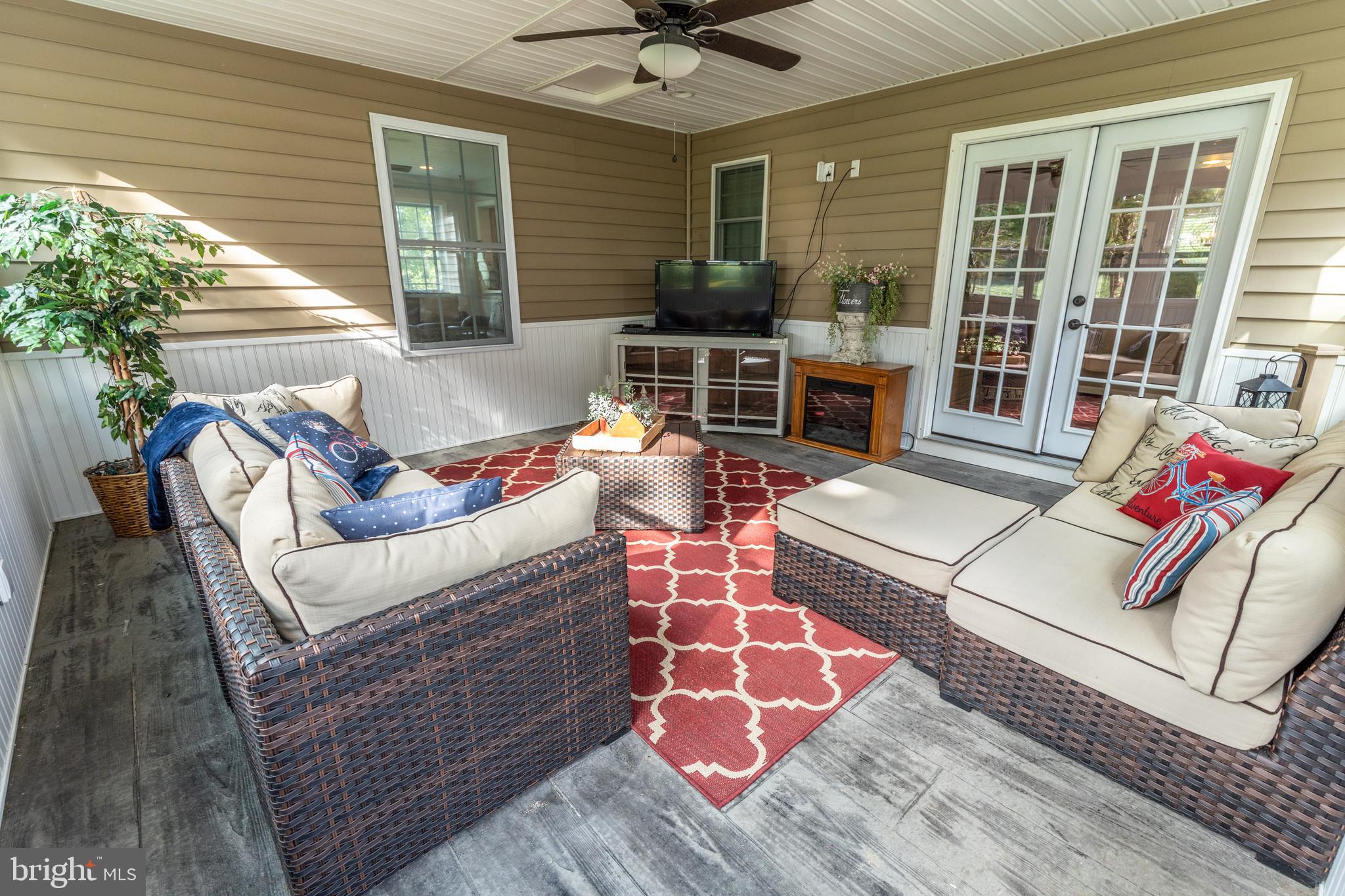 193 Quail Run Road Summit Point, WV 25446 - Photo 59 of 72 a view of a patio with couches chairs and potted plants