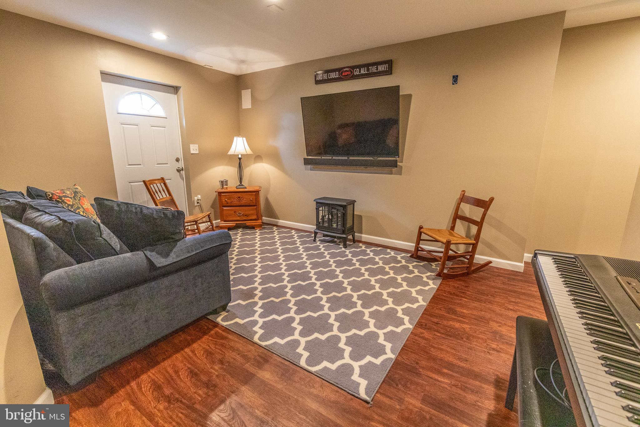 193 Quail Run Road Summit Point, WV 25446 - Photo 63 of 72 a living room with furniture and a flat screen tv