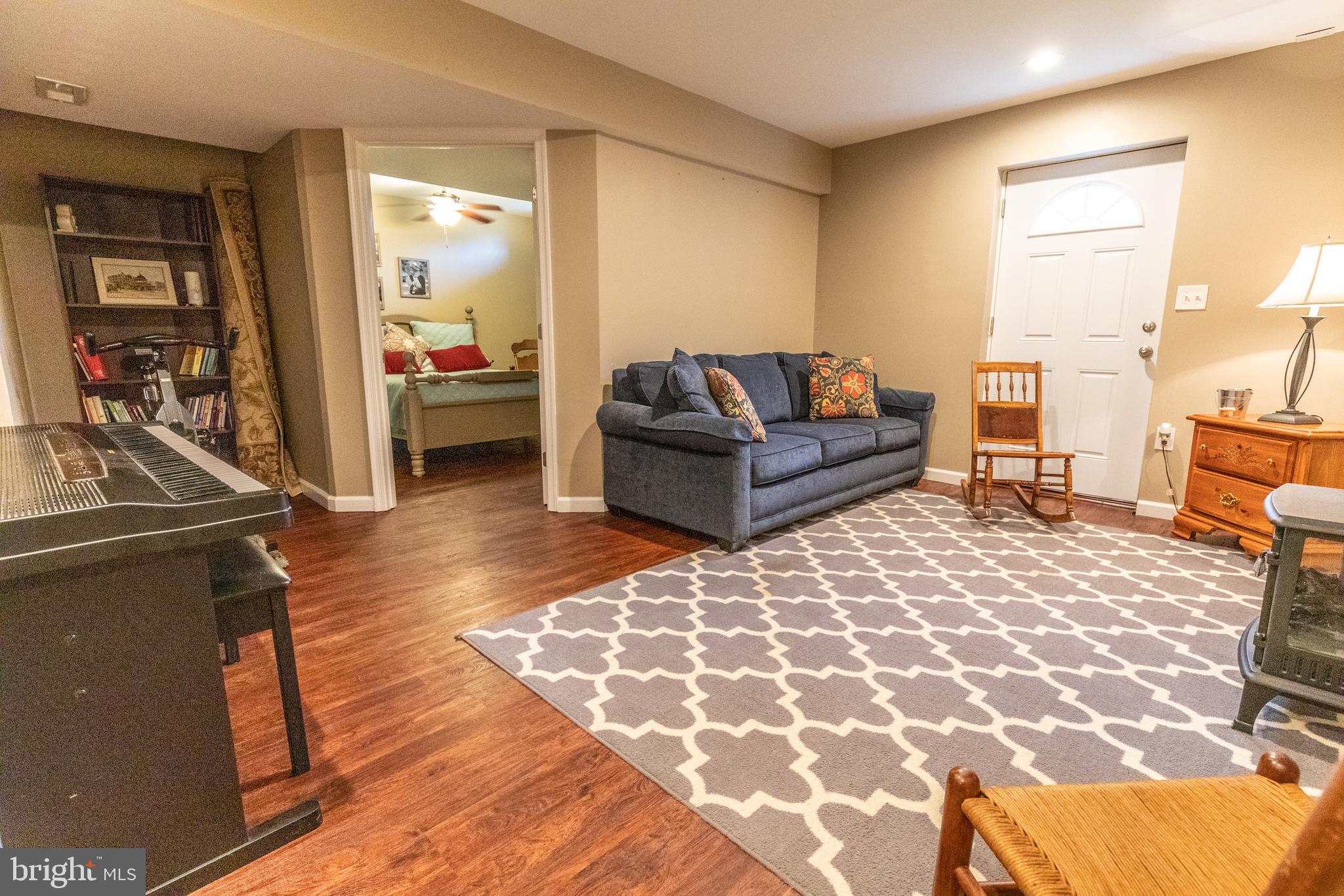 193 Quail Run Road Summit Point, WV 25446 - Photo 64 of 72 a living room with furniture and a rug