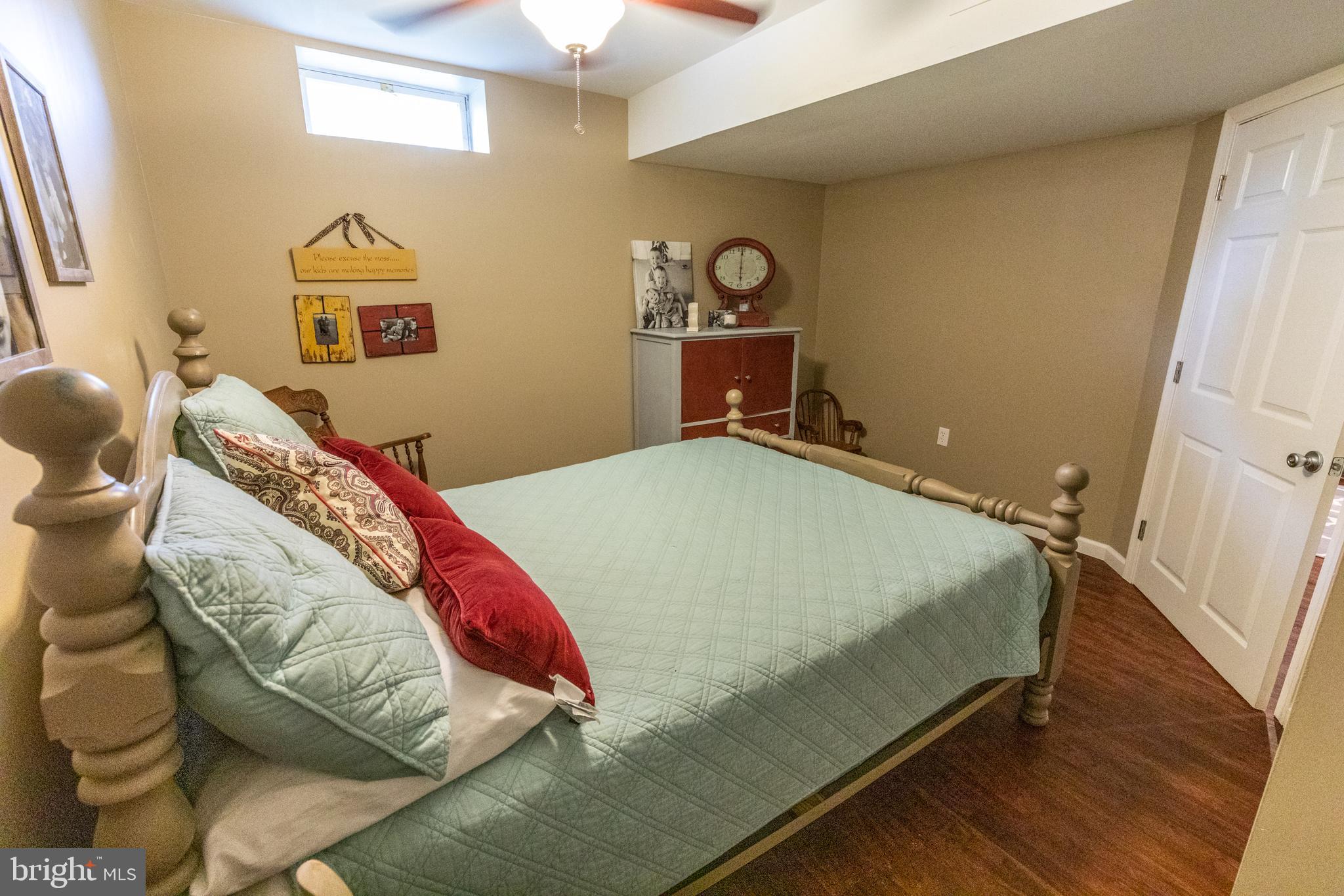 193 Quail Run Road Summit Point, WV 25446 - Photo 66 of 72 a bed sitting in a bedroom next to a window