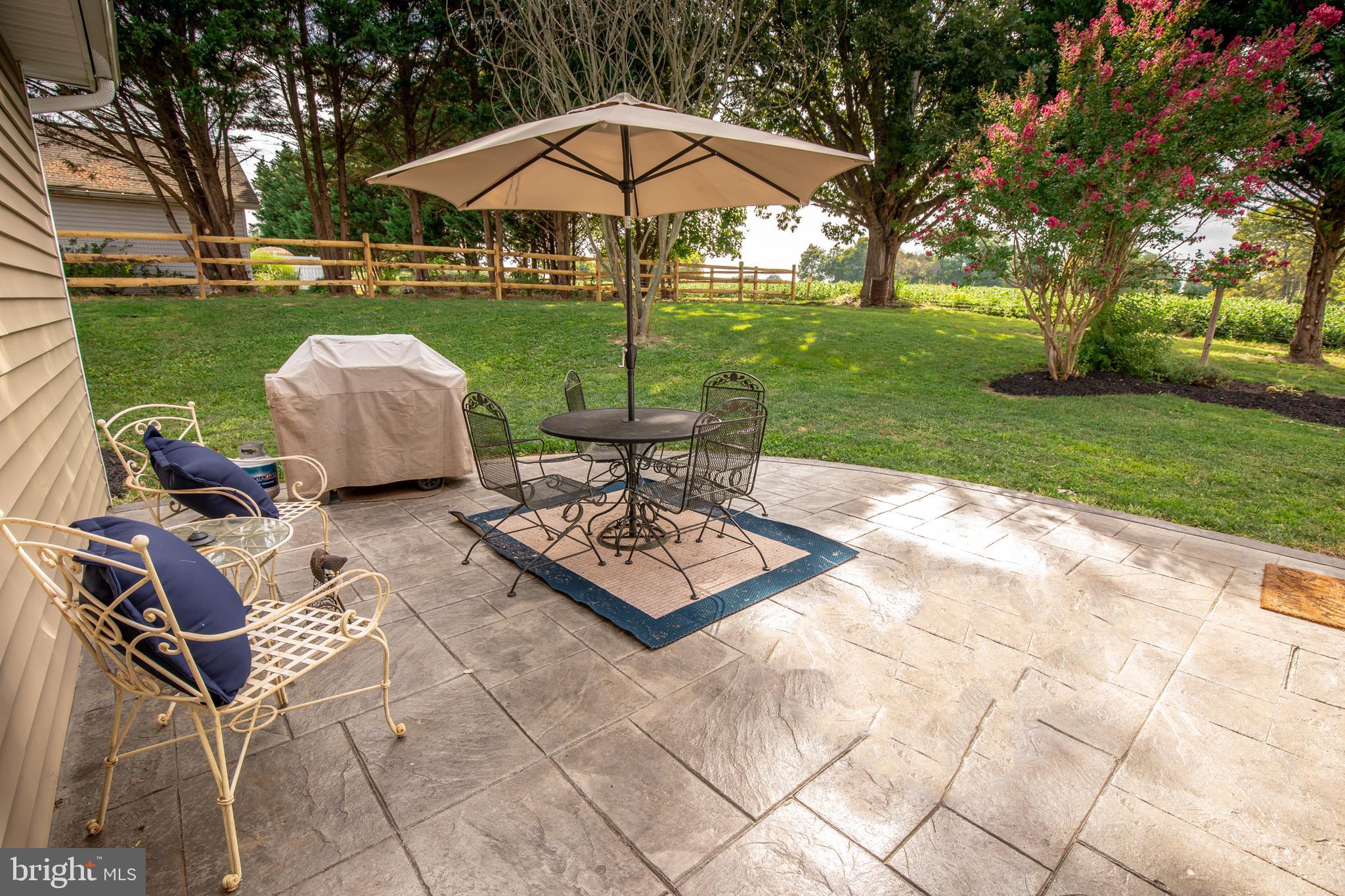 193 Quail Run Road Summit Point, WV 25446 - Photo 8 of 72 a view of a table and chairs under an umbrella