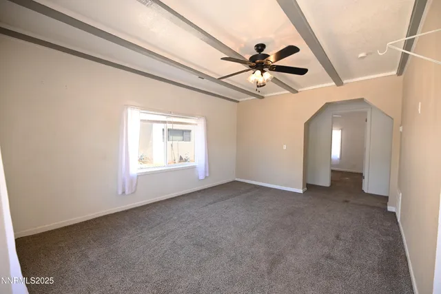 an aerial view of a house with yard and parking