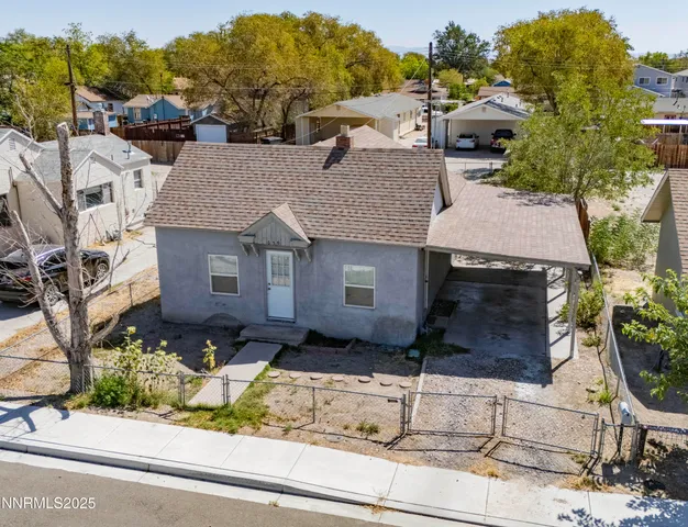 an aerial view of a residential houses with outdoor space