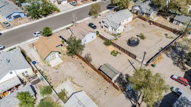 an aerial view of a house with a yard and pool