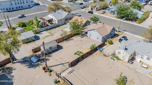 an aerial view of a house with a garden and parking