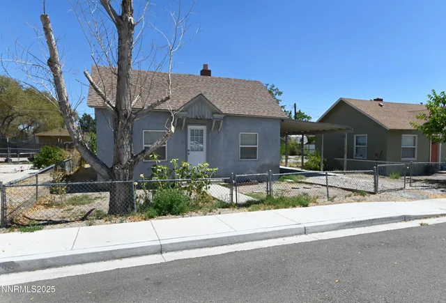 a view of a house with a small yard and plants