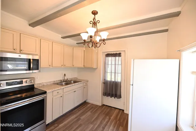 a kitchen with a sink stove and microwave