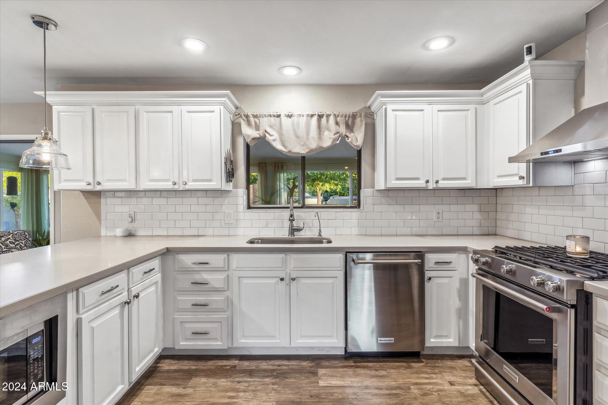 8019 North 7th Avenue Phoenix, AZ 85021 - Photo 19 of 43 a kitchen with stainless steel appliances granite countertop a stove a sink and a microwave