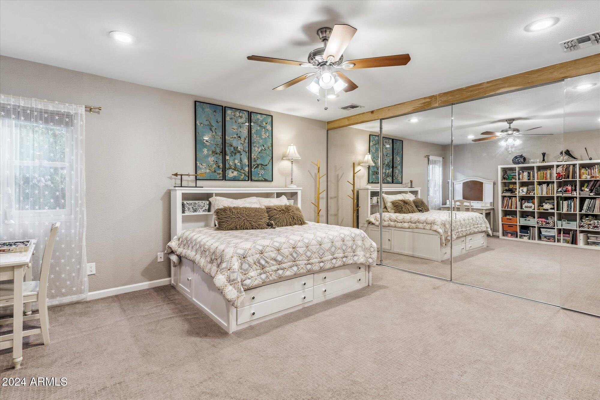 8019 North 7th Avenue Phoenix, AZ 85021 - Photo 22 of 43 a spacious bedroom with a large bed and a chandelier
