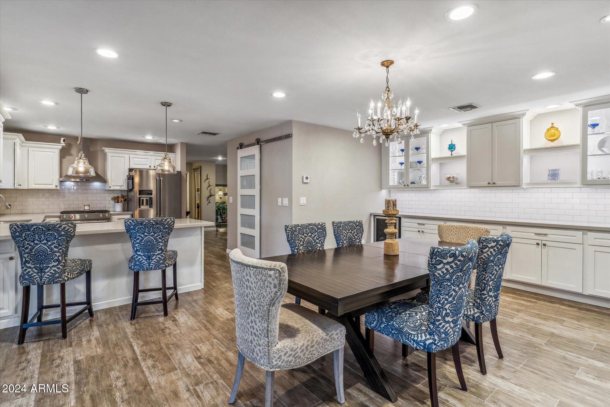 8019 North 7th Avenue Phoenix, AZ 85021 - Photo 10 of 43 a view of a dining room with furniture and wooden floor