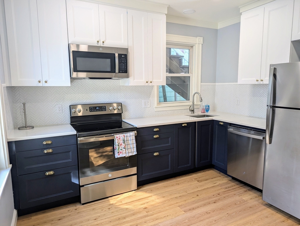 60 Day Street, Unit 1 Boston, MA 02130 - Photo 4 of 10 a kitchen with a refrigerator stove and microwave