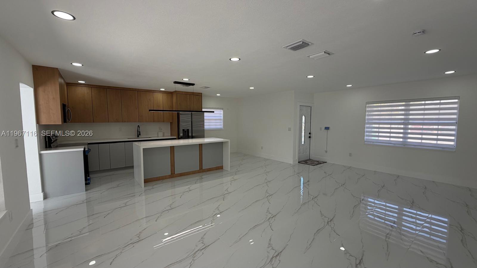 9620 Southwest 9th Terrace Miami, FL 33174 - Photo 16 of 26 a kitchen with stainless steel appliances granite countertop a sink and cabinets
