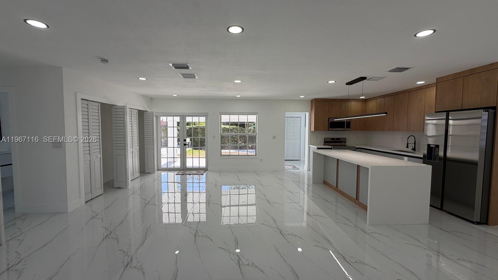 9620 Southwest 9th Terrace Miami, FL 33174 - Photo 17 of 26 a large kitchen with stainless steel appliances a large counter top and a refrigerator