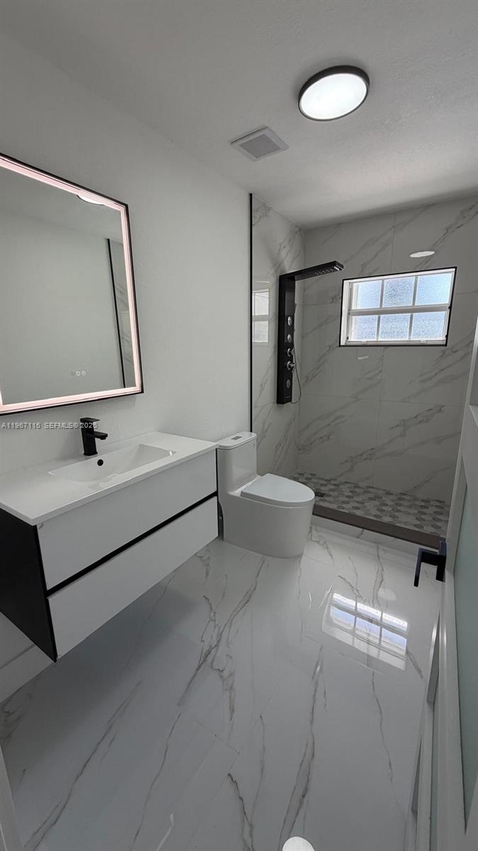 9620 Southwest 9th Terrace Miami, FL 33174 - Photo 4 of 26 a bathroom with a toilet sink and mirror