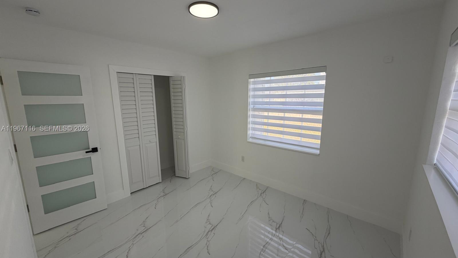 9620 Southwest 9th Terrace Miami, FL 33174 - Photo 7 of 26 a view of an empty room with a window