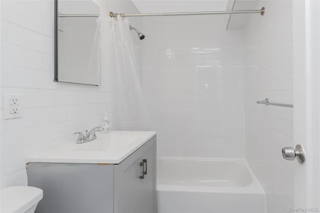 a bathroom with a shower and a sink