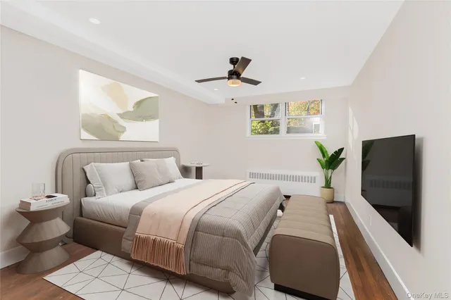 a bedroom with a large bed and a flat screen tv