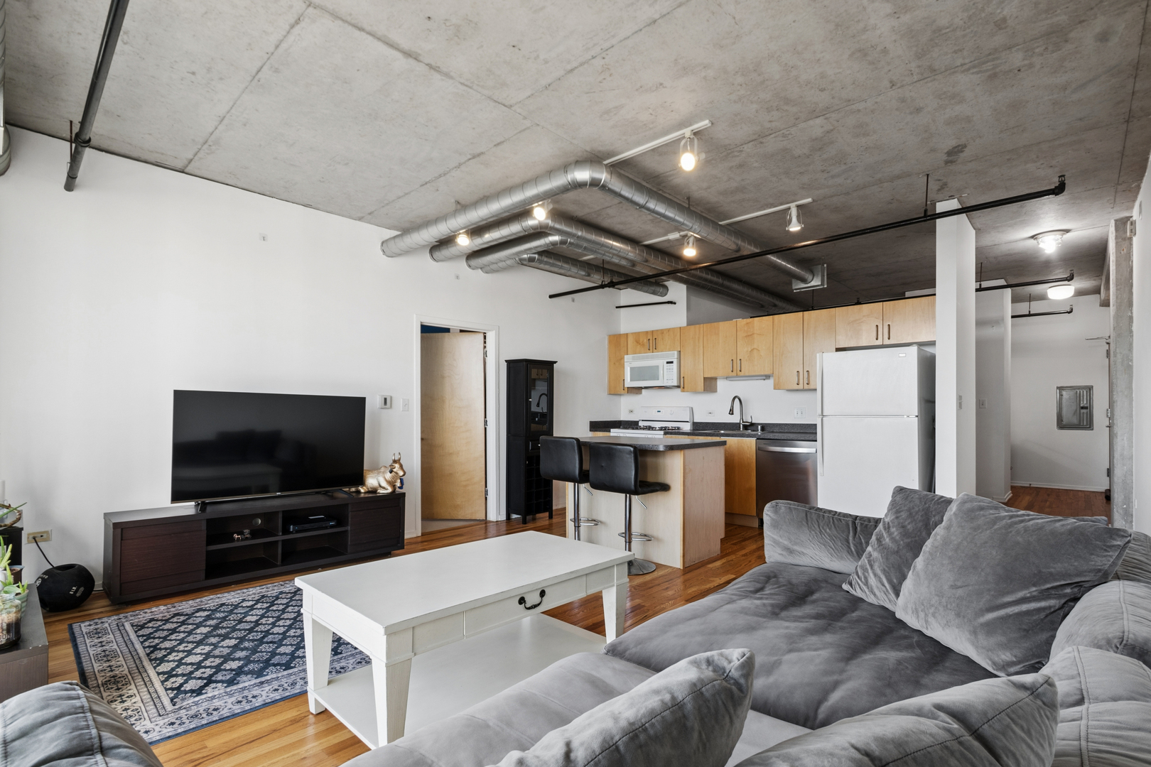 700 West Van Buren Street, Unit 1105 Chicago, IL 60607 - Photo 11 of 19 a living room with furniture and a flat screen tv