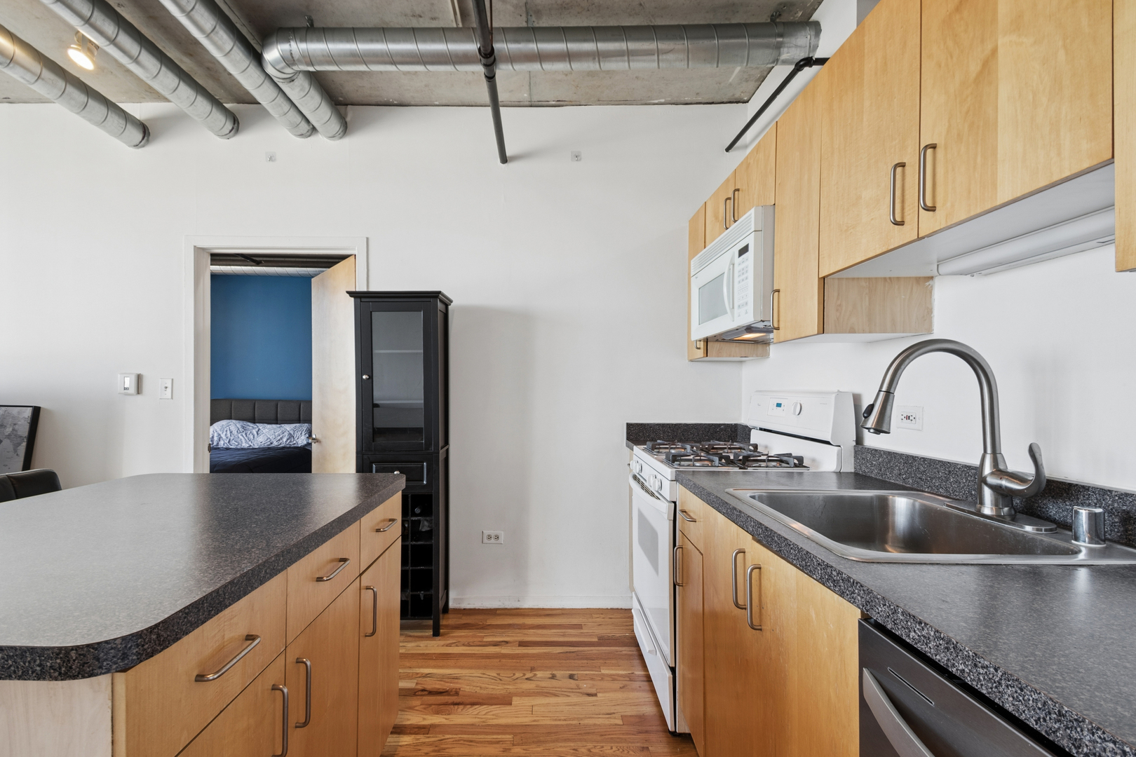 700 West Van Buren Street, Unit 1105 Chicago, IL 60607 - Photo 6 of 19 a kitchen with stainless steel appliances granite countertop a sink a stove and cabinets