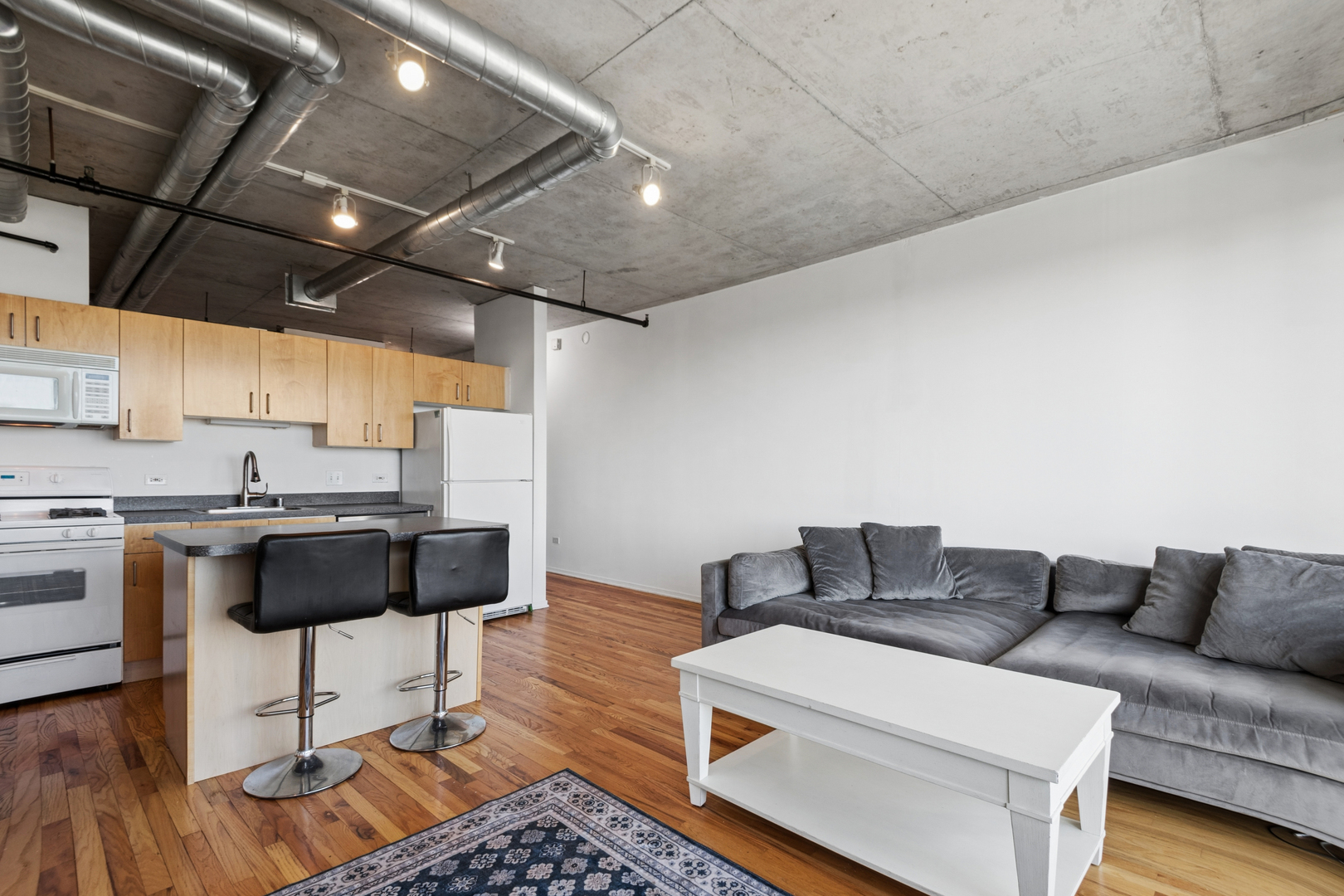 700 West Van Buren Street, Unit 1105 Chicago, IL 60607 - Photo 8 of 19 a living room with a couch and a counter top space