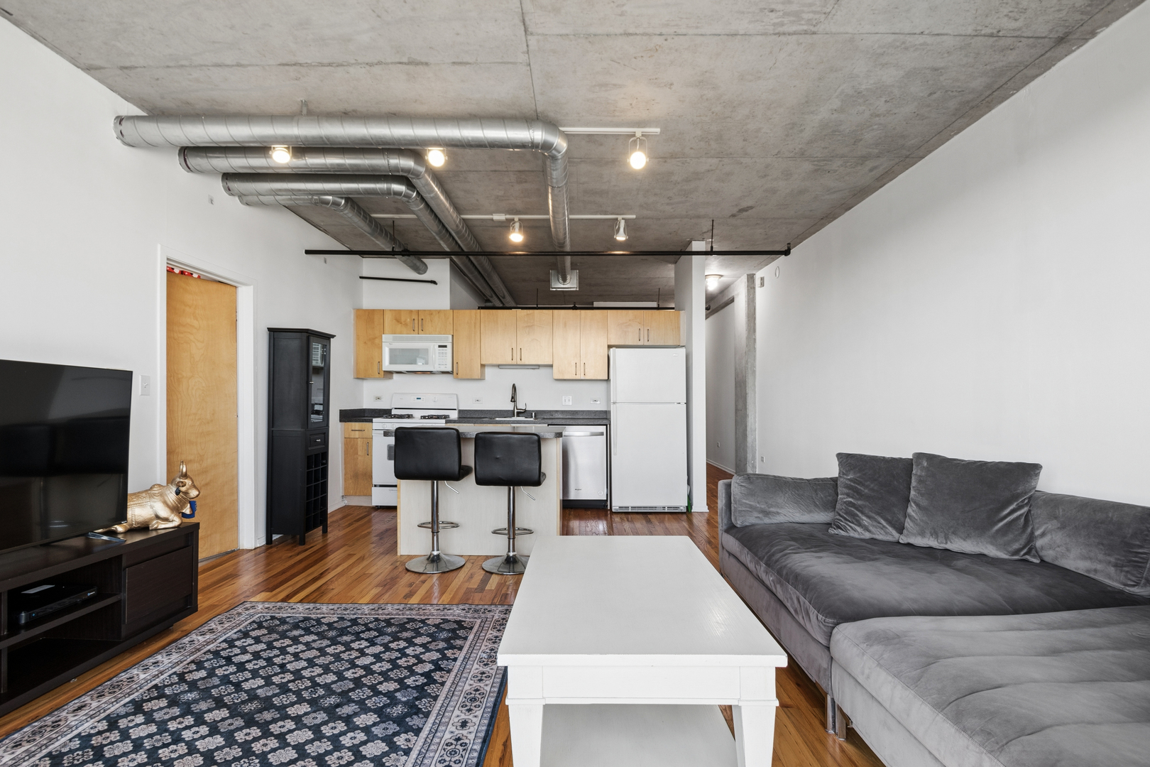 700 West Van Buren Street, Unit 1105 Chicago, IL 60607 - Photo 9 of 19 a living room with furniture and a flat screen tv