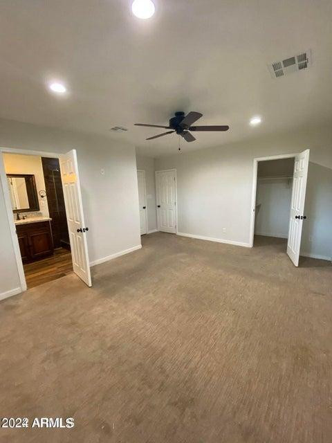 1011 West Northern Avenue Phoenix, AZ 85021 - Photo 14 of 25 an empty room with staircase and a ceiling fan