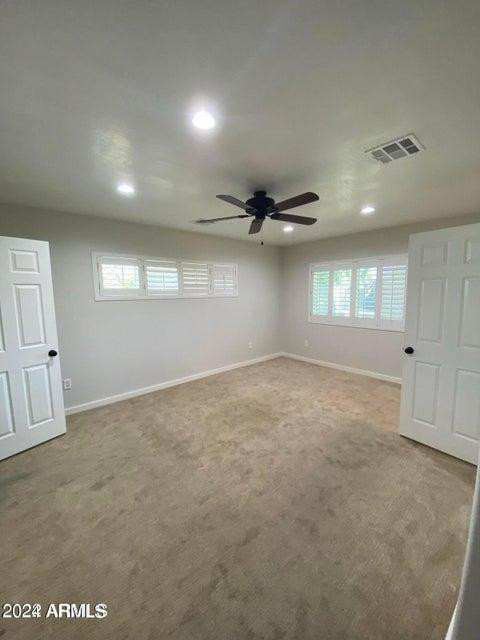 1011 West Northern Avenue Phoenix, AZ 85021 - Photo 16 of 25 an empty room with windows and ceiling fan