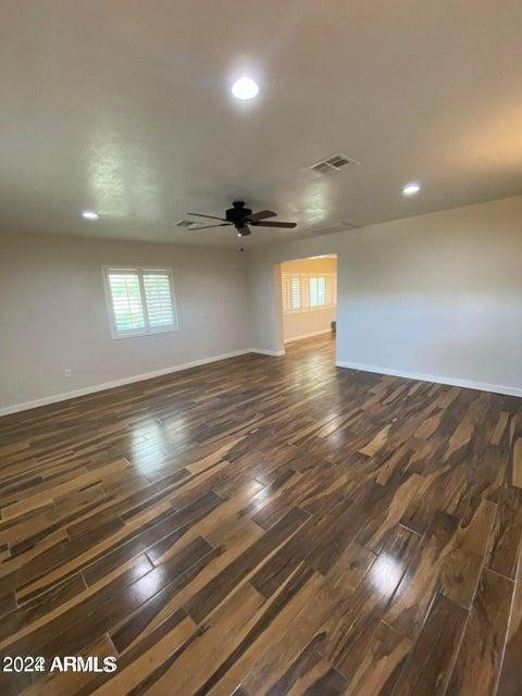 1011 West Northern Avenue Phoenix, AZ 85021 - Photo 4 of 25 an empty room with wooden floor and windows