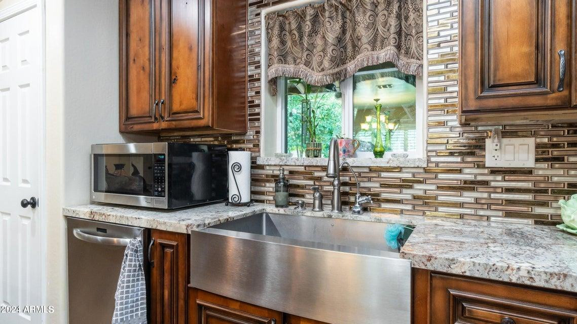 1011 West Northern Avenue Phoenix, AZ 85021 - Photo 8 of 25 a kitchen with stainless steel appliances granite countertop a sink a stove and a microwave