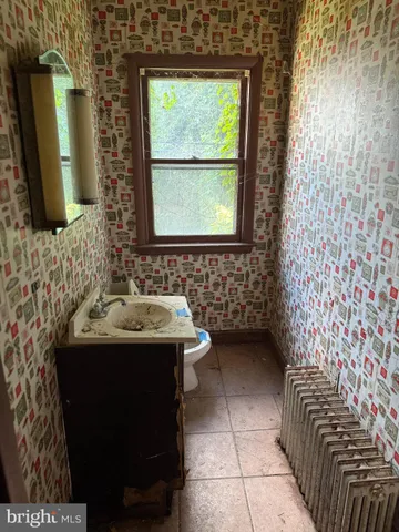a bathroom with a sink shower and a mirror