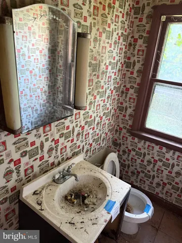 a living room with a window and a chandelier