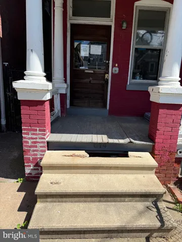 a view of a roof deck with couches and wooden floor