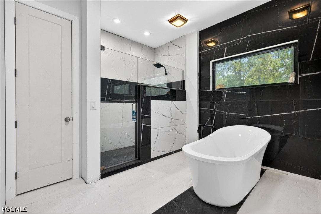 2665 Oil Well Road Naples, FL 34120 - Photo 15 of 40 a bathroom with a toilet a sink and mirror