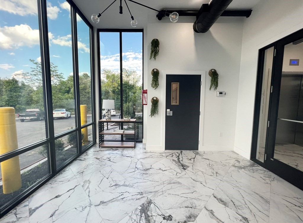 80 Bridge Street, Unit 308 Dedham, MA 02026 - Photo 2 of 19 a view of a room with large windows