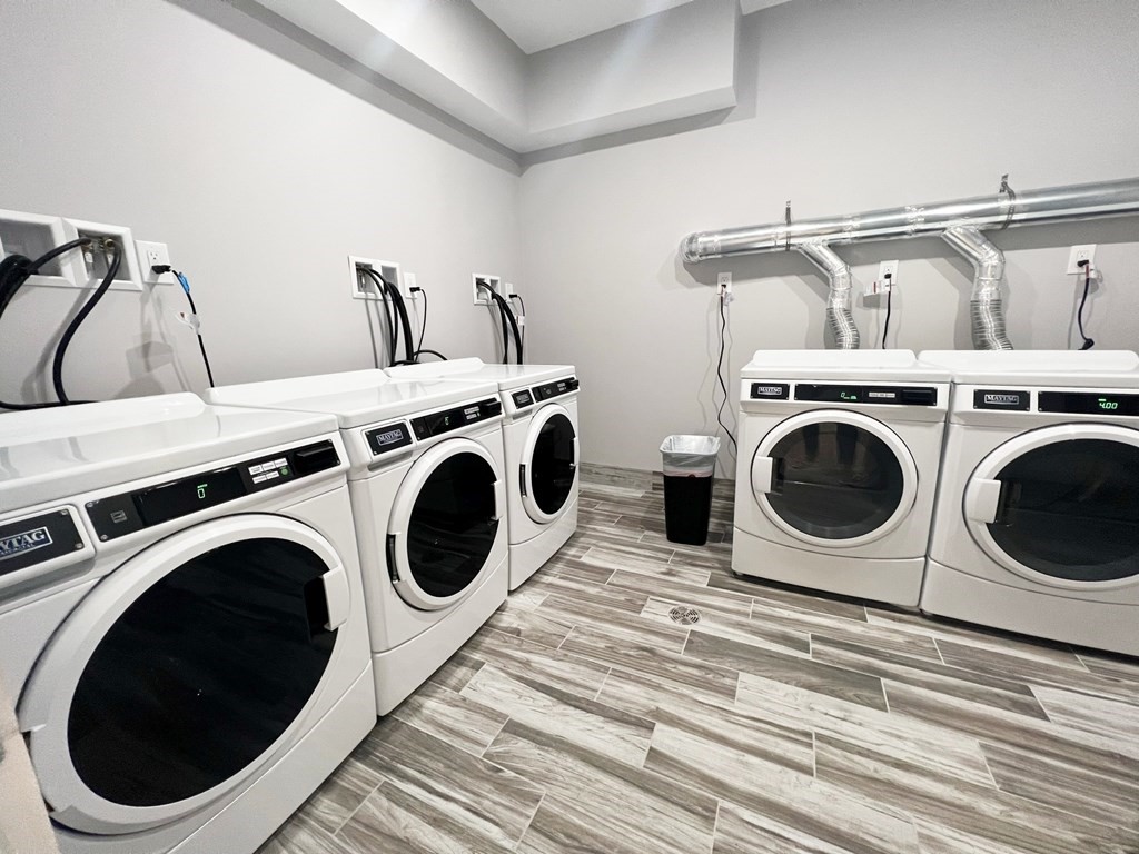 80 Bridge Street, Unit 308 Dedham, MA 02026 - Photo 5 of 19 a utility room with dryer washer and empty racks
