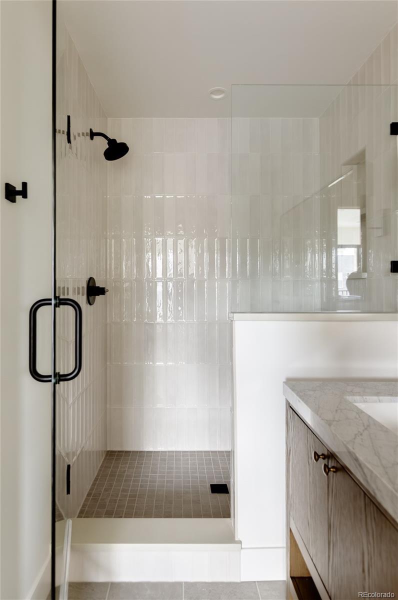 1749 North Williams Street, Unit 2 Denver, CO 80218 - Photo 21 of 34 a bathroom with a granite countertop sink a mirror and shower