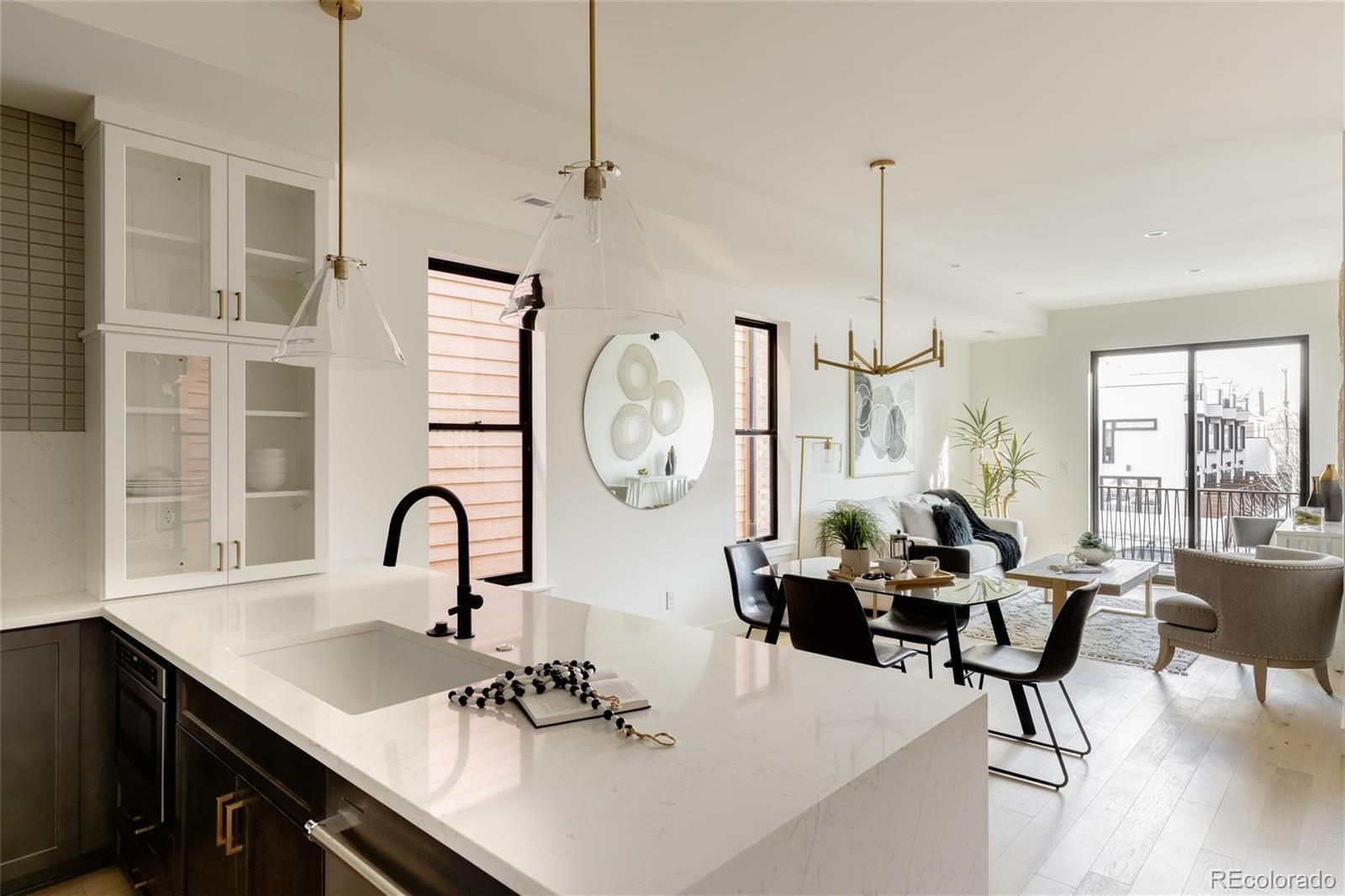 1749 North Williams Street, Unit 2 Denver, CO 80218 - Photo 10 of 34 a living room with furniture a large window and a chandelier