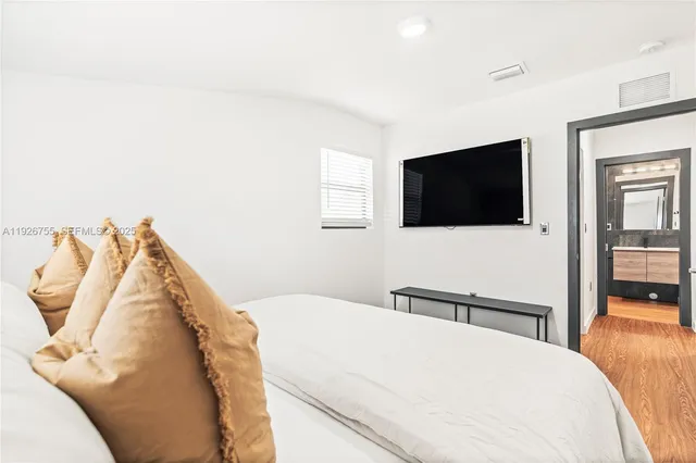 a bedroom with a bed and a flat screen tv