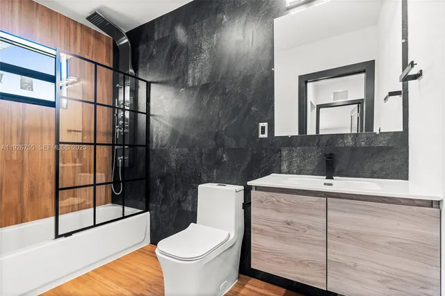 a bathroom with a sink toilet and shower
