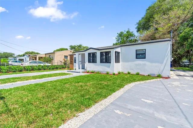 a front view of house with yard and green space