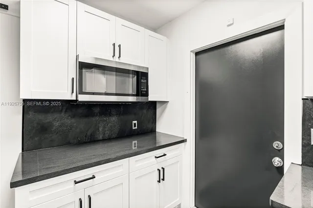 a kitchen with a microwave and a sink