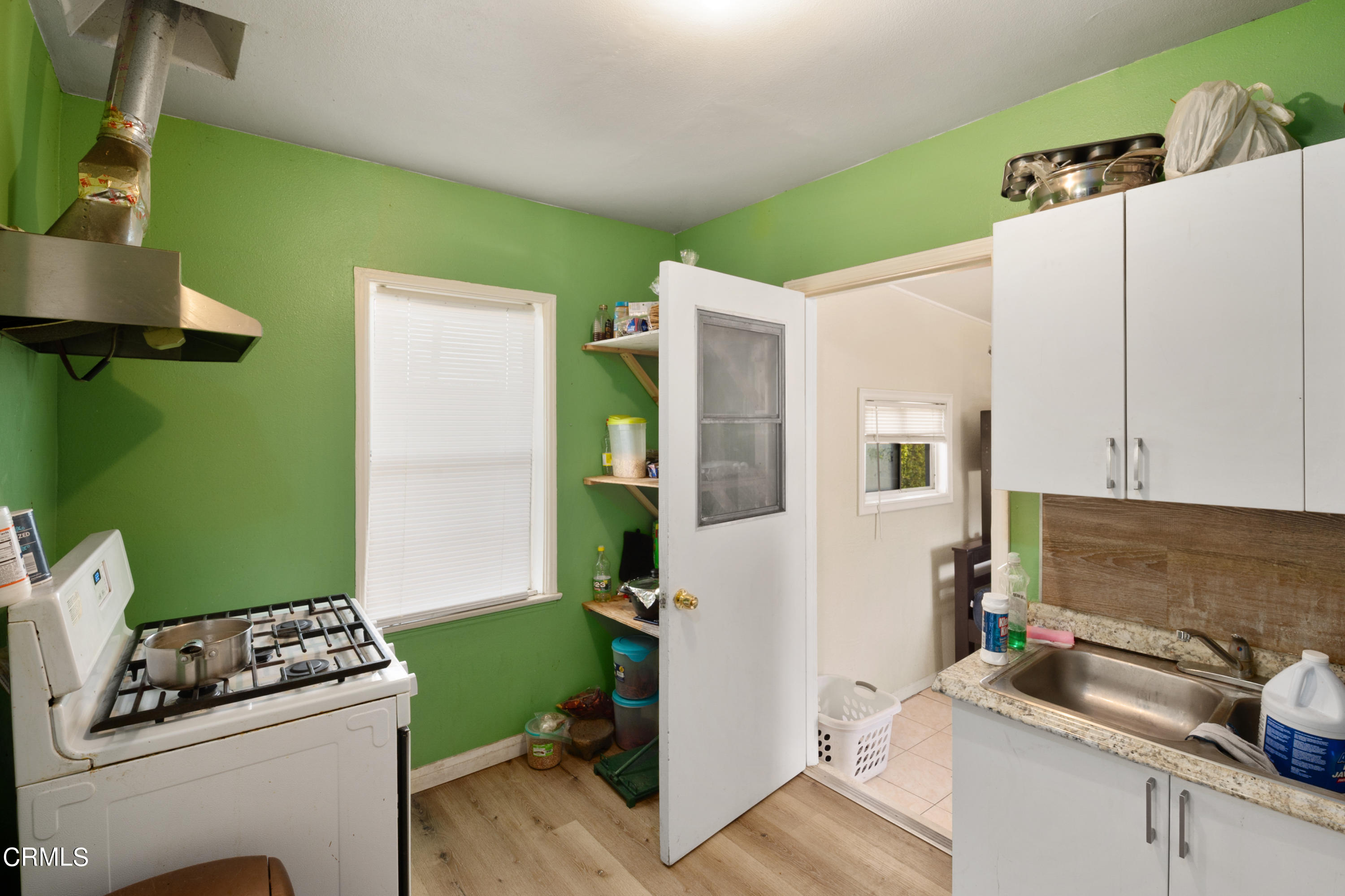 11208 Aster Street Ventura, CA 93004 - Photo 11 of 33 a kitchen with a refrigerator and a stove top oven