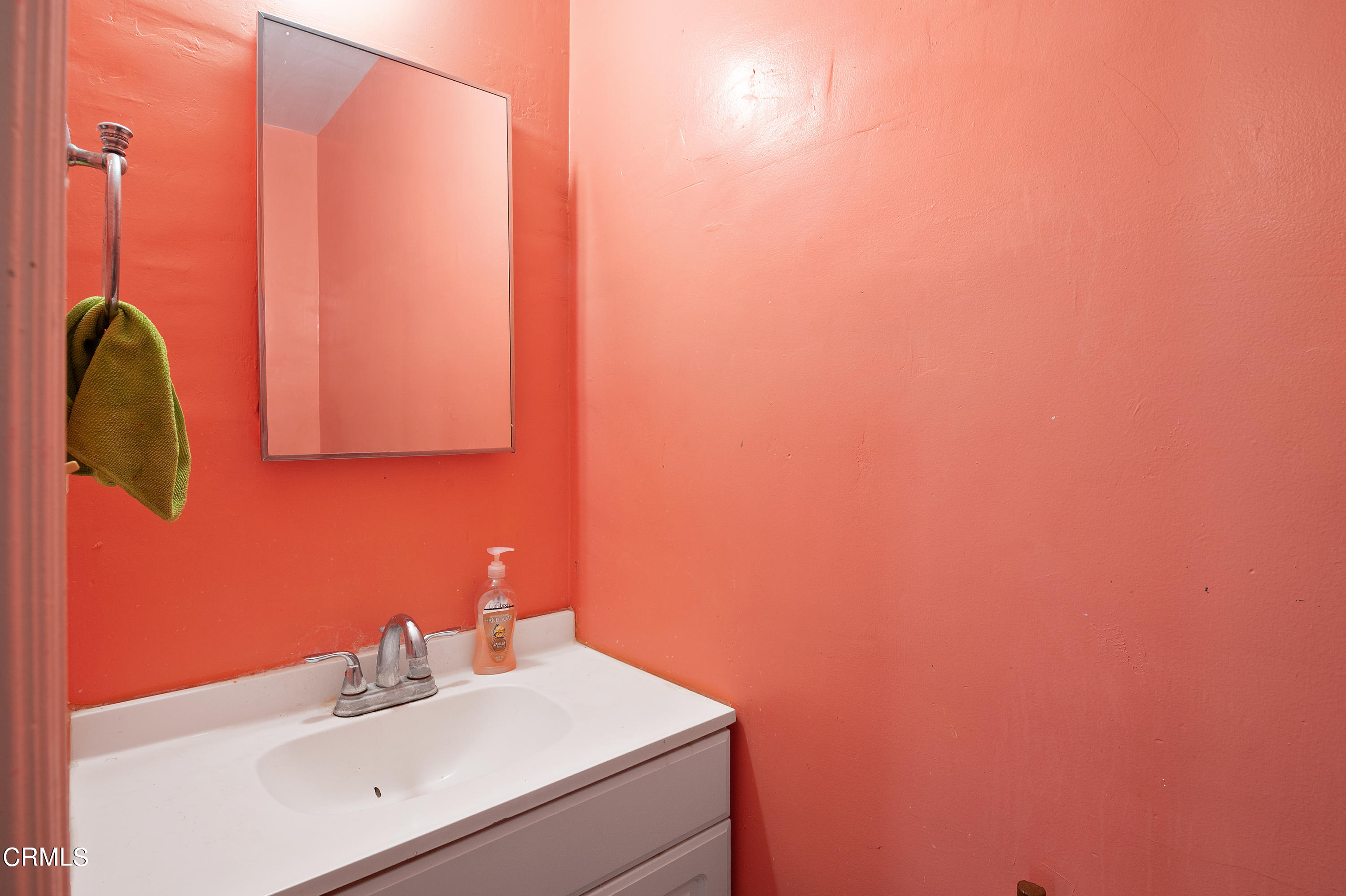 11208 Aster Street Ventura, CA 93004 - Photo 18 of 33 a bathroom with a sink and a mirror