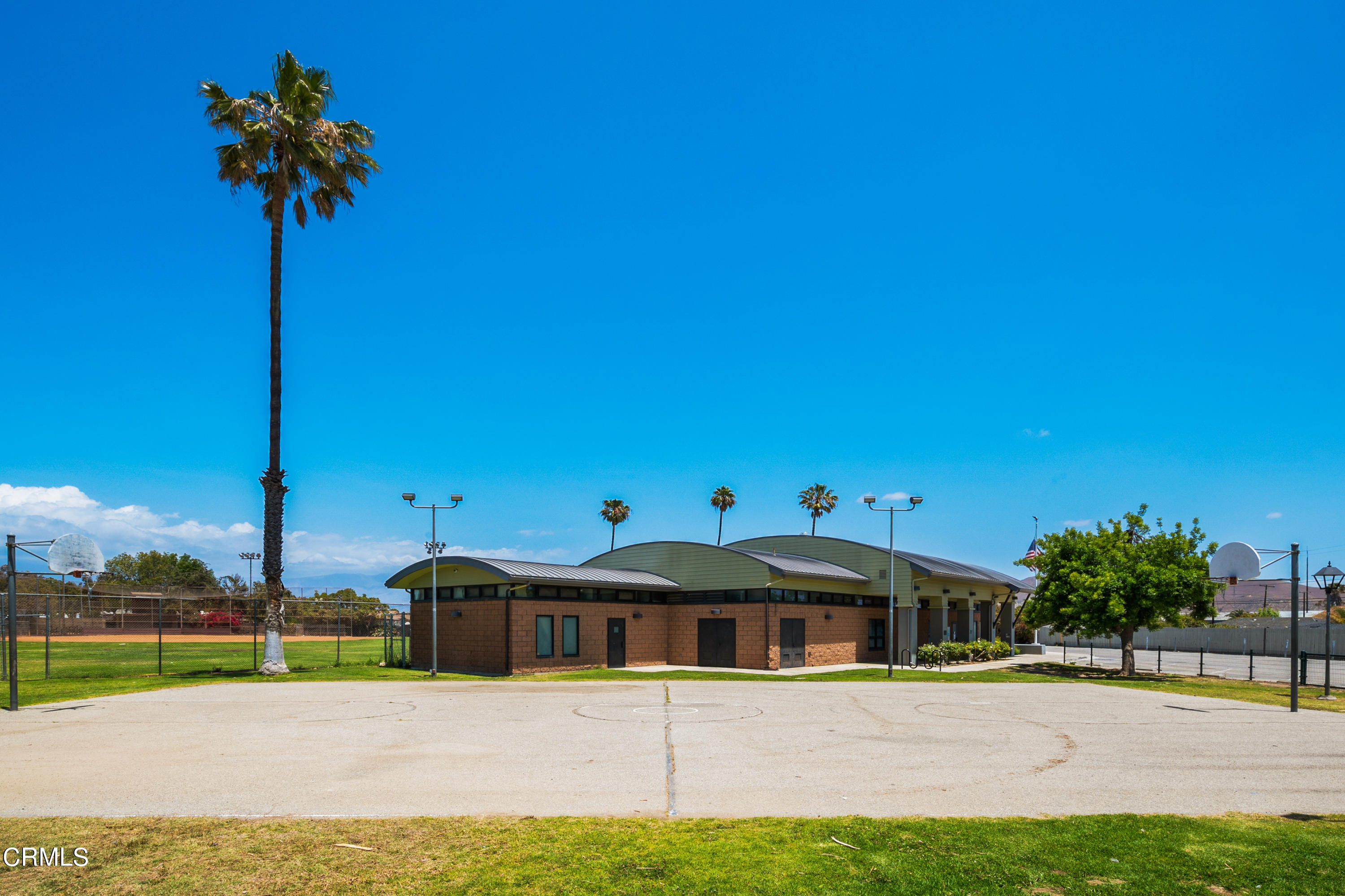 11208 Aster Street Ventura, CA 93004 - Photo 29 of 33 a front view of a house with a yard and palm trees