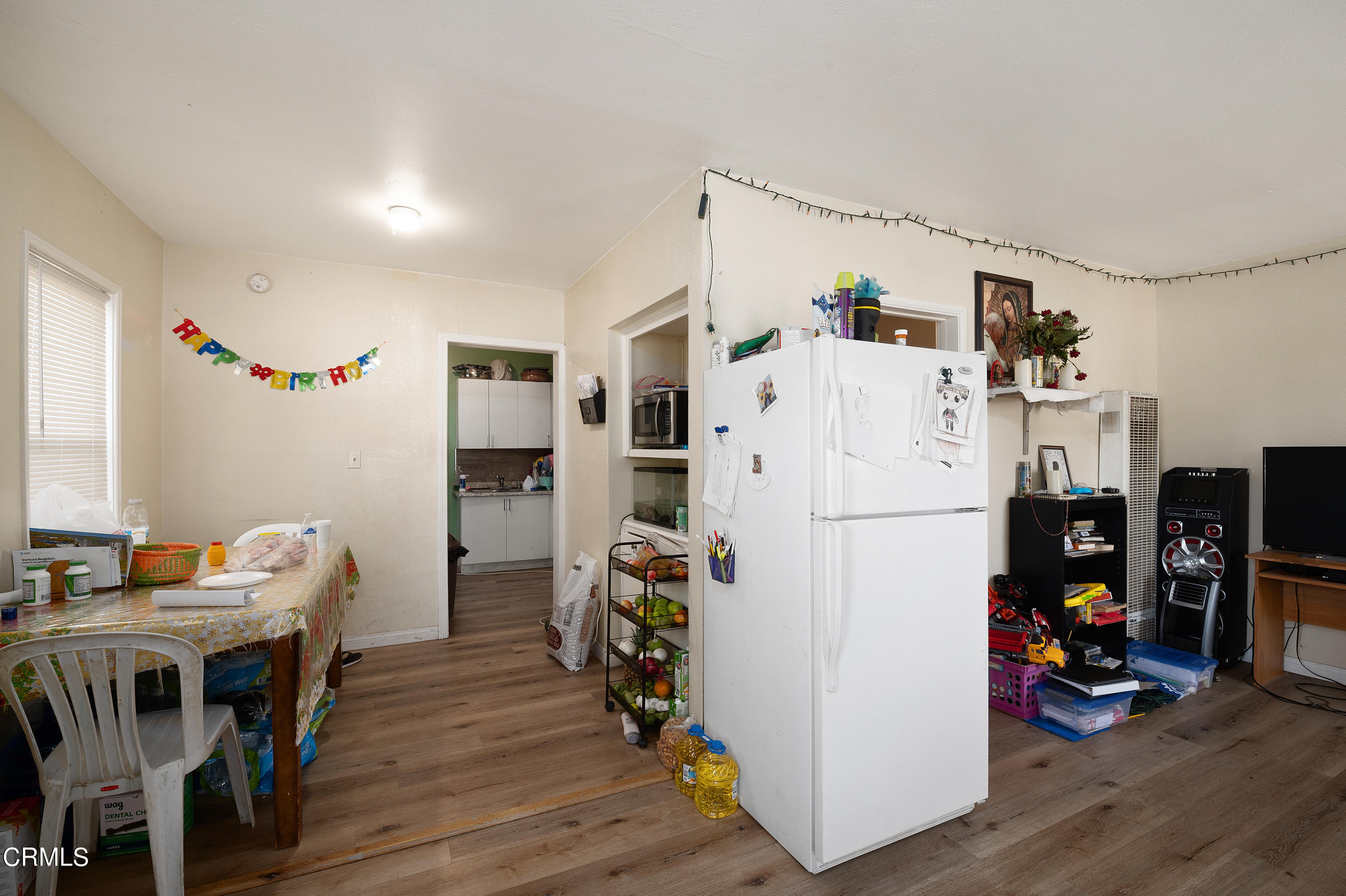 11208 Aster Street Ventura, CA 93004 - Photo 5 of 33 a view of a kitchen with fridge and workspace