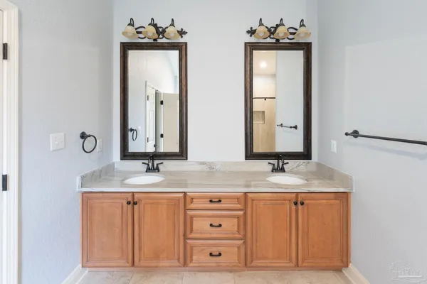 a bathroom with a sink vanity and mirror