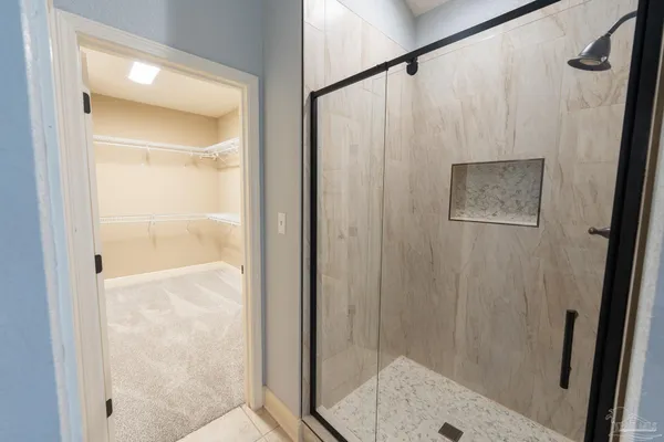 a bathroom with a shower and a sink