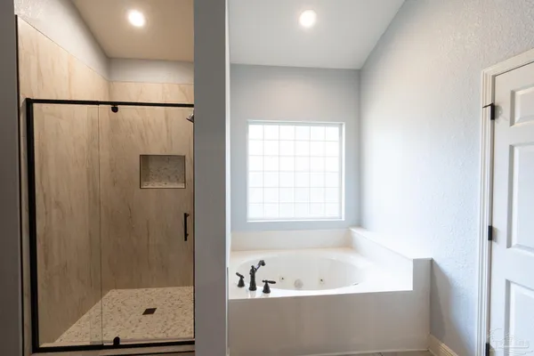 a bathroom with a bathtub and a shower