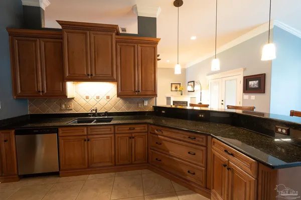 a kitchen with granite countertop wooden cabinets and a sink