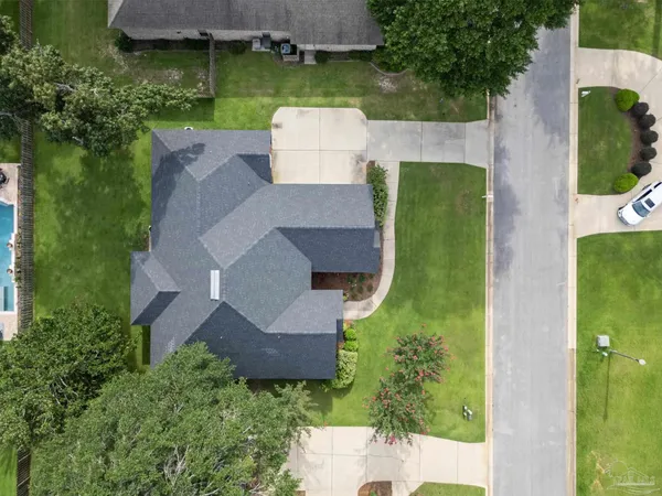 an aerial view of a house with outdoor space pool seating area and yard